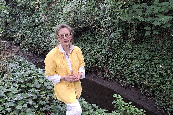 Caroline in front of a chalk stream